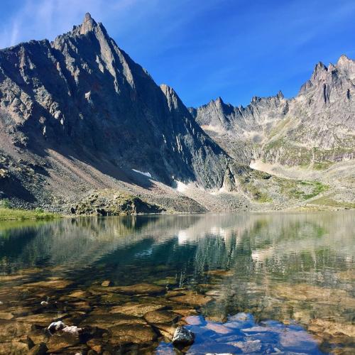 Mount monolith in front of a crystal clear lake