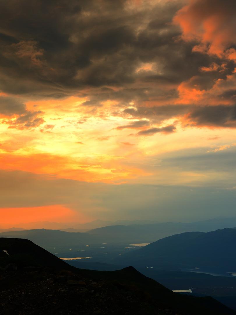 The sun sets over Keno from the top of Keno Hill sign post